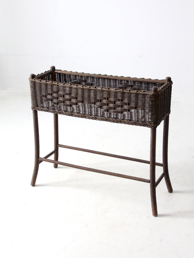 antique woven wicker planter stand