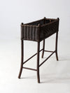 antique woven wicker planter stand