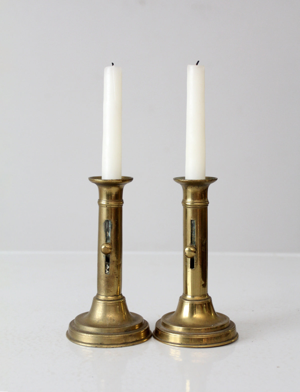 antique brass push-up candlestick holders pair