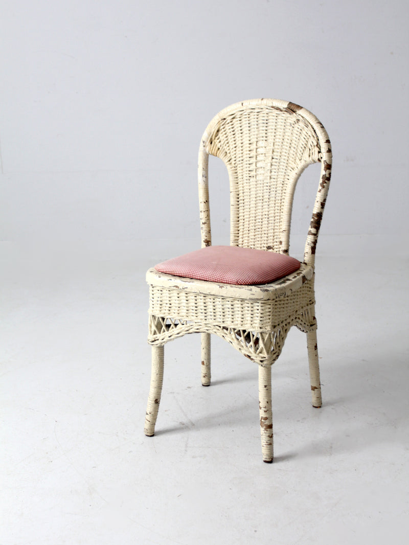 antique wicker chair with gingham cushioned seat