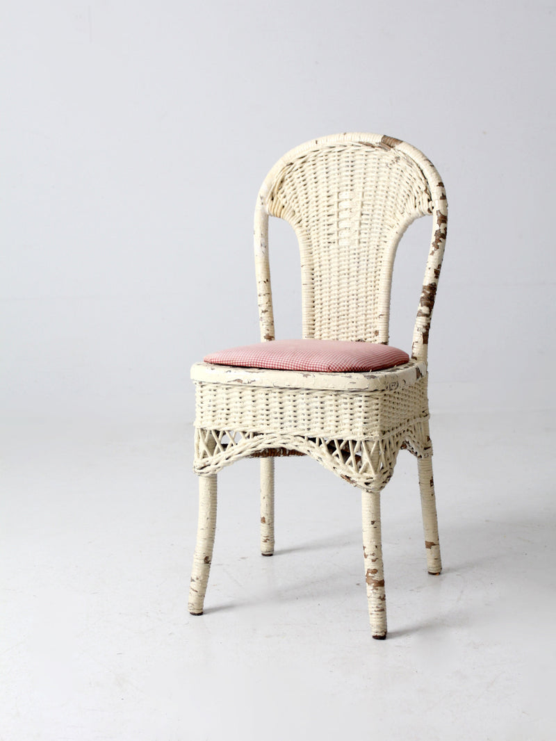 antique wicker chair with gingham cushioned seat