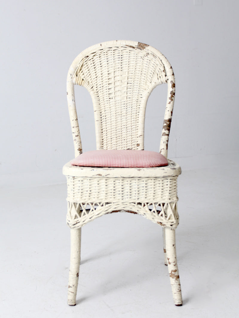 antique wicker chair with gingham cushioned seat