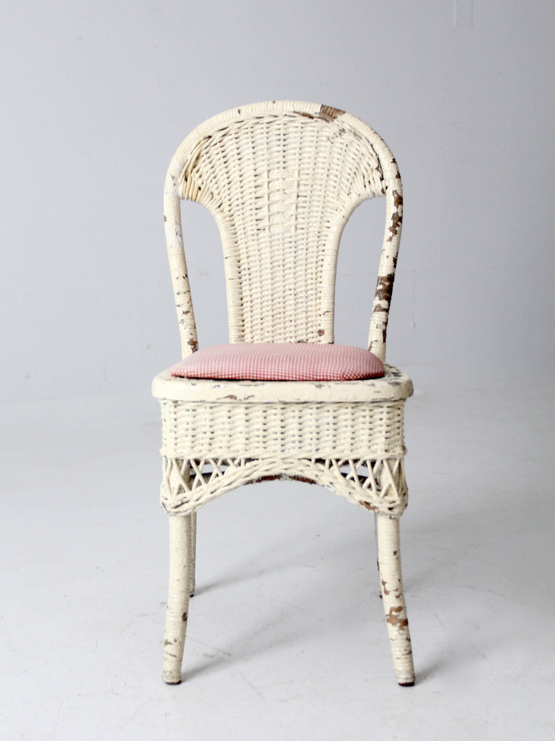 antique wicker chair with gingham cushioned seat