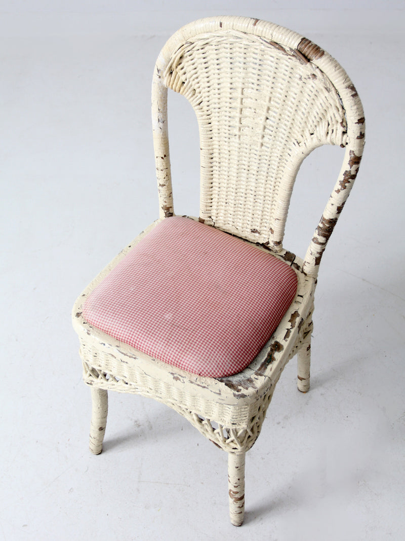 antique wicker chair with gingham cushioned seat