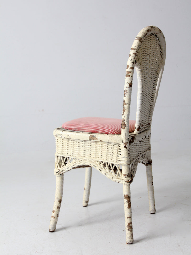 antique wicker chair with gingham cushioned seat