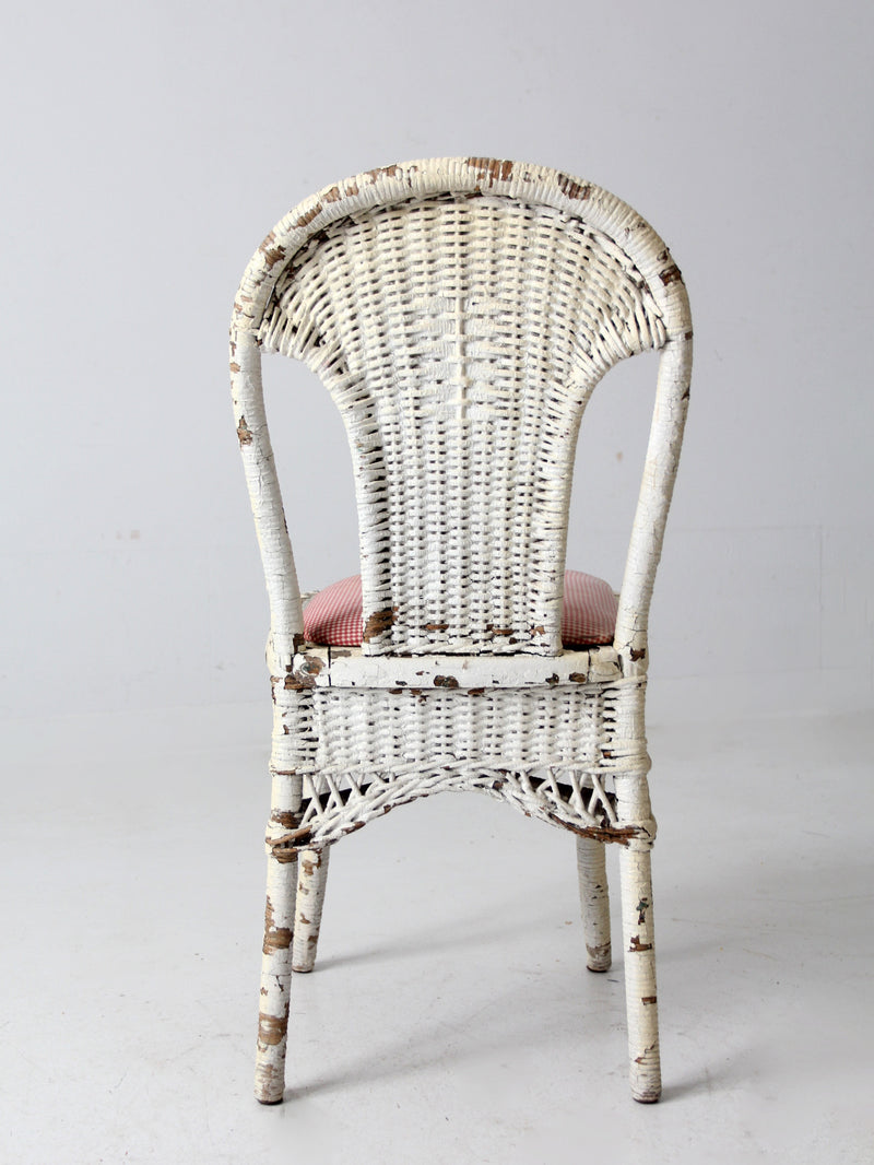 antique wicker chair with gingham cushioned seat