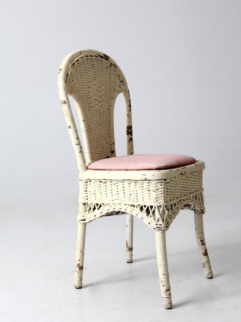 antique wicker chair with gingham cushioned seat