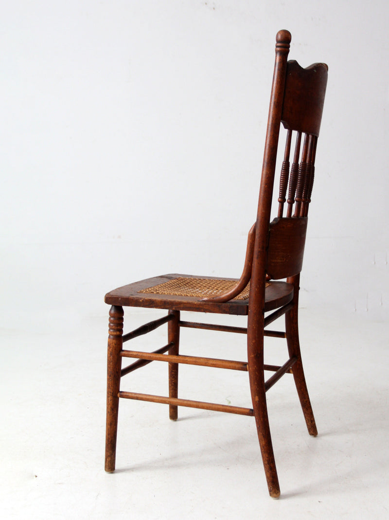 antique pressed back chair with cane seat