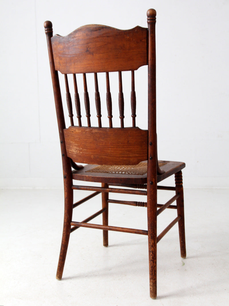 antique pressed back chair with cane seat